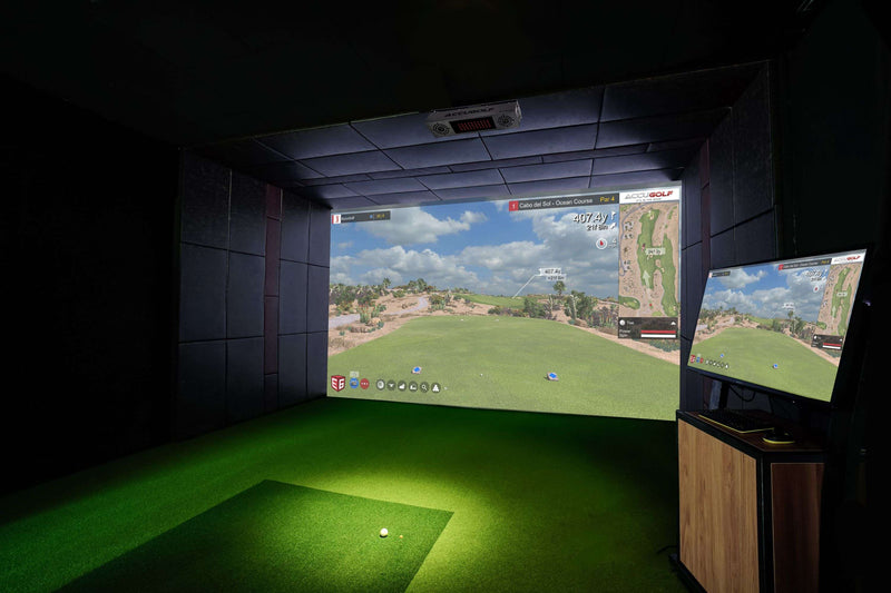 Indoor golf simulator setup with a screen displaying a golf course.