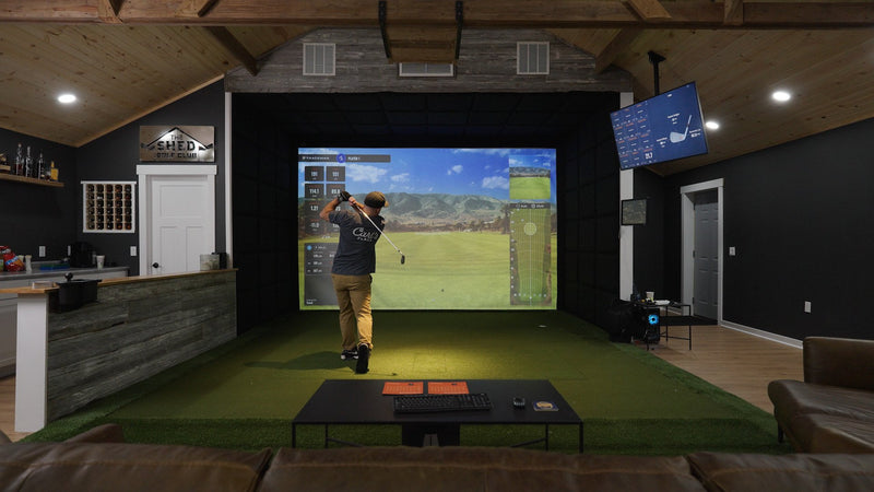 Man hitting into impact screen in finished simulator room