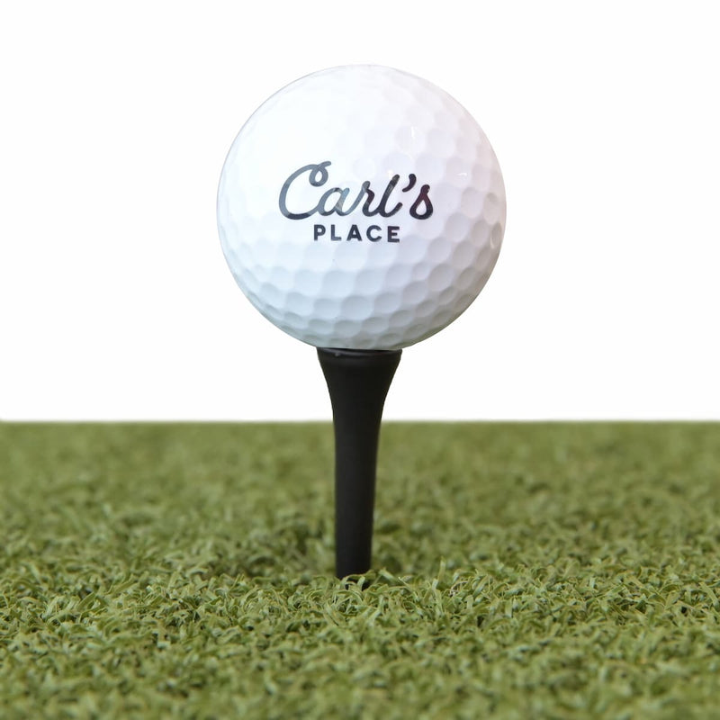 Golf ball teed up on turf