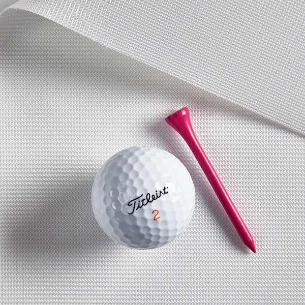 Golf ball and tee on woven screen material